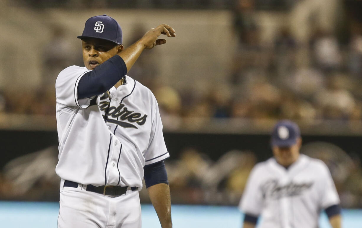 San Diego Padres starting pitcher Edinson Volquez wipes this face as he battles in the first inning against the Chicago Cubs where he allowed six runs in the baseball game on Friday, Aug. 23, 2013, in San Diego.