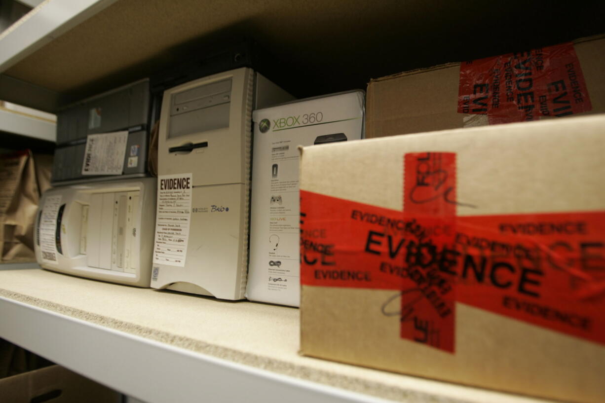 Confiscated computers and child-oriented pornographic tapes fill the storeroom shelves in the Florida Attorney General's Child Predator CyberCrime Unit office in Jacksonville, Fla.