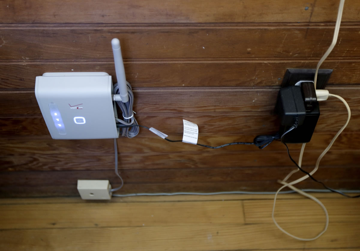 In this Friday, May 31, 2013 photo, a wireless device that can be connected to a home phone for service is seen inside Robert Post's home, in Mantoloking, N.J., which was flooded during Superstorm Sandy last year. Post has a pacemaker that needs to be checked once a month by phone, but the  phone company refuses to restore the area's landlines after they were damaged by the storm. Verizon doesnit want to replace washed-away lines and waterlogged underground cables because phone lines are outdated, it says. Meanwhile, the company is offering the wireless device, but the system does not work with pacemakers or fax machines.