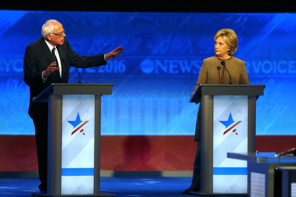 Bernie Sanders, left, offers an apology to Hillary Clinton during a Democratic presidential primary debate Saturday, Dec. 19, 2015, at Saint Anselm College in Manchester, N.H.