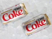 Two cans of Caffeine Free Diet Coke on ice.