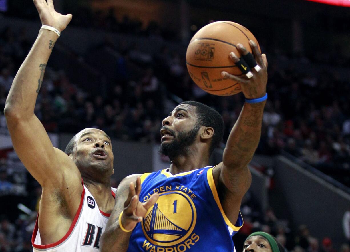 Dorell Wright drives against Marcus Camby of the Blazers during the 2010-2011 season.