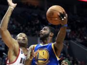 Dorell Wright drives against Marcus Camby of the Blazers during the 2010-2011 season.