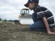 Derek Fechtner, 6, of Woodland, waits patiently in line for his chance to drive a full-sized bulldozer during the annual Dozer Days fundraiser at the Cemex/Fisher Quarry in 2012.