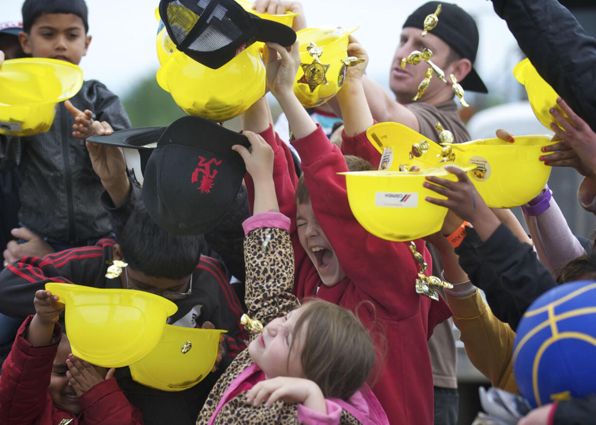 Tommy Aldin, 10, center in red, reacts after being hit in the head with hard candies being dumped by a conveyer truck during last year's Dozer Days.