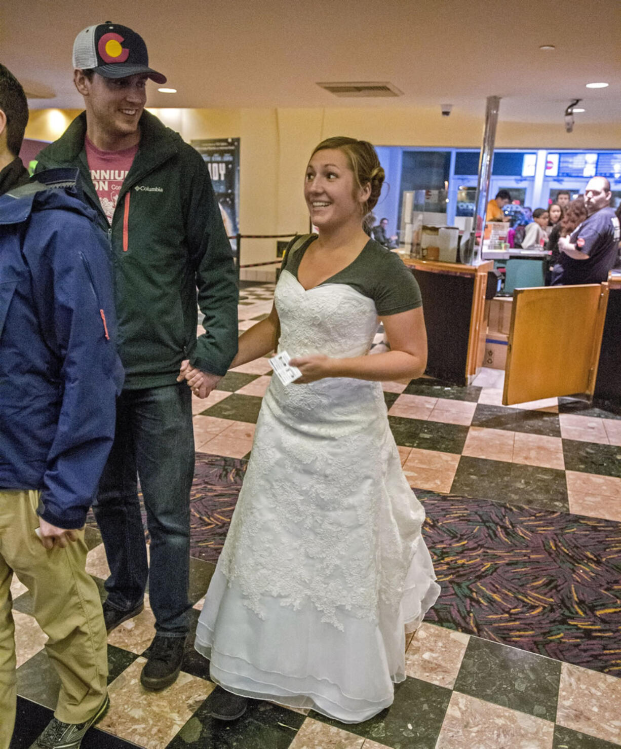 Kelsey and James Beil stand in the lobby of AMC Lakewood Mall 12 movie theater to see &quot;Star Wars: The Force Awakens,&quot; Dec. 19. She&#039;s wearing her wedding dress and a &quot;Star Wars&quot; T-shirt to keep her promise on a Facebook fundraising challenge.