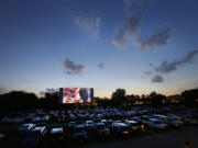 People watch a movie as the sun sets over Bengies Drive-In Theatre in Middle River, Md.