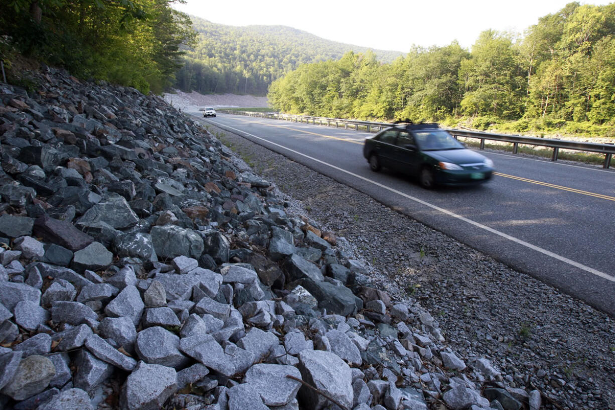 Cars travel on the rebuilt Vermont Route 107 in Bethel, Vt.