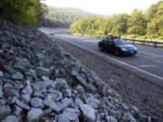 Cars travel on the rebuilt Vermont Route 107 in Bethel, Vt.