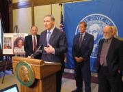 Washington Gov. Jay Inslee, second from left, is joined by lawmakers as he talks to the media about a new proposal for tougher penalties for drunken drivers Tuesday in Olympia.