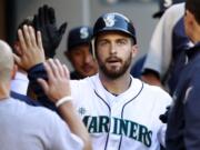 Seattle Mariners' Dustin Ackley is congratulated on his home run against the Toronto Blue Jays in the first inning of a baseball game, Tuesday, July 31, 2012, in Seattle.