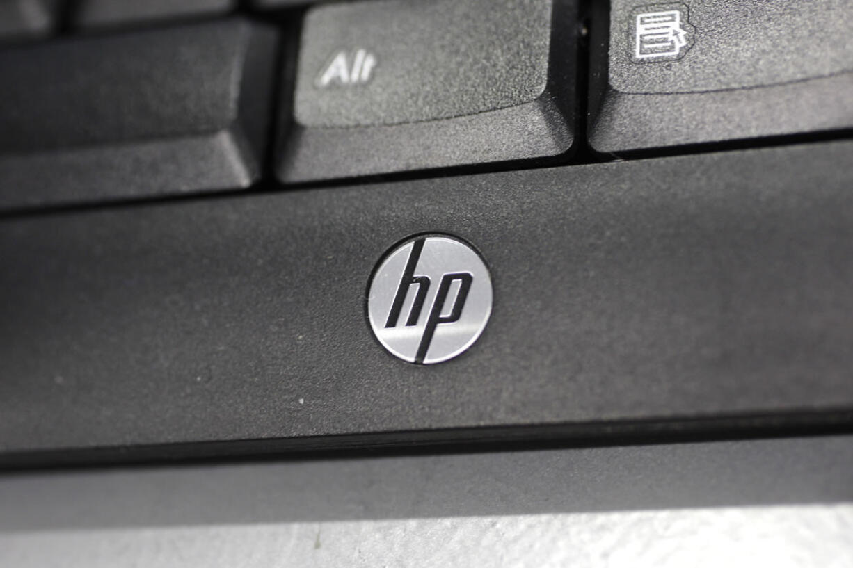 In this Monday, Aug. 20, 2012, photo, a Hewlett Packard keyboard is displayed at a Best Buy store in Mountain View, Calif. On Wednesday, Aug. 22, 2012, Hewlett-Packard Co. said it suffered an $8.9 billion loss during its most recent quarter after taking a previously announced charge against earnings for an acquisition that hasn't panned out the way management envisioned.