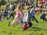 Kids race for eggs during  the start of an Easter egg hunt at Kiwanis Park in Battle Ground.