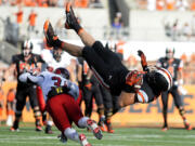 Oregon State's Connor Hamlett (89) flips over Eastern Washington's T.J. Lee (31) while leaping to catch a pass in the third quarter Saturday Aug. 31, 2013 in Corvallis, Ore.