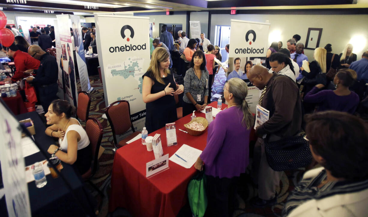 People check out opportunities during a job fair in Miami Lakes, Fla. U.S.