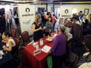 People check out opportunities during a job fair in Miami Lakes, Fla. U.S.