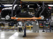 Jeff Caldwell, 29, right, a chassis assembly line supervisor, checks a vehicle on the assembly line at the Chrysler Jefferson North Assembly plant in Detroit.