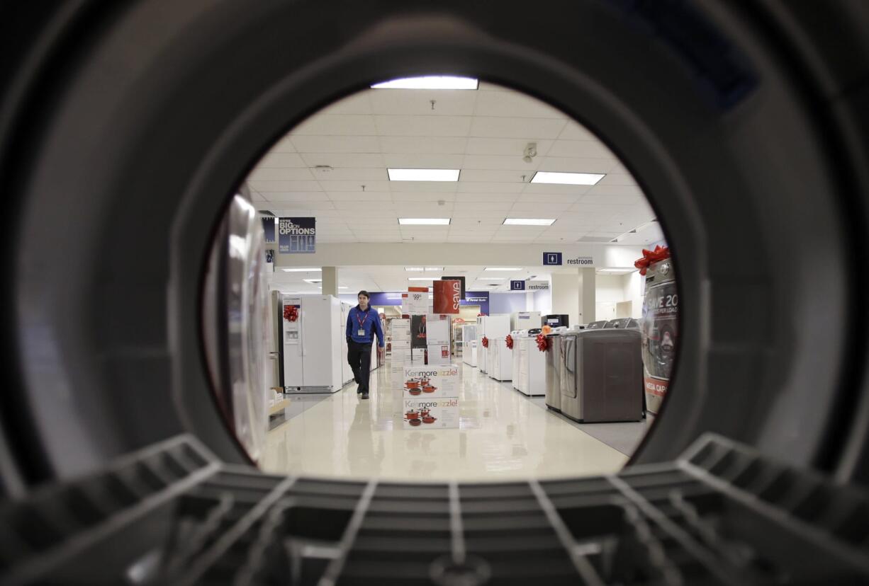 Mark Duncan/Associated Press Files
An employee walks through the appliance department at a Sears in North Olmsted, Ohio. Despite fears about the sequester, consumers are continuing to buy.