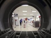 Mark Duncan/Associated Press Files
An employee walks through the appliance department at a Sears in North Olmsted, Ohio. Despite fears about the sequester, consumers are continuing to buy.