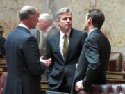 Republican Sen. Steve Litzow, center, talks with Majority Coalition Caucus leader Rodney Tom, left, and Democratic Sen.