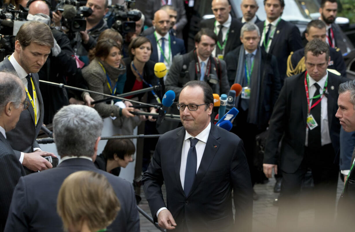 French President Francois Hollande, center, arrives for an EU summit in Brussels on Thursday. European Union heads of state meet Thursday to discuss, among other issues, the current migration crisis and terrorism.