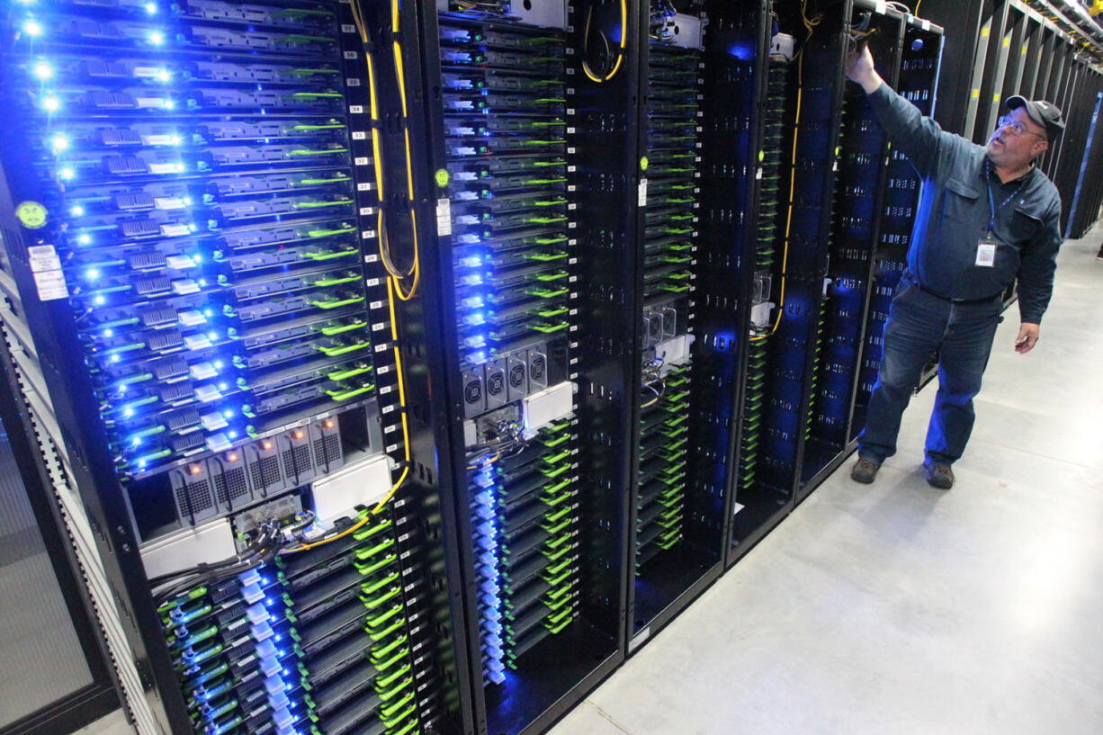 Chuck Goolsbee, site director for Facebook's Prineville data centers, shows the computer servers that store users' photos and other data at the Facebook site in Prineville Ore..