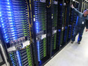 Chuck Goolsbee, site director for Facebook's Prineville data centers, shows the computer servers that store users' photos and other data at the Facebook site in Prineville Ore..