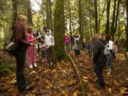 Lauriel Schuman, left, leads a guided mushroom hunting hike at Columbia Springs Family Field Trip Day, Saturday, November 3, 2012.