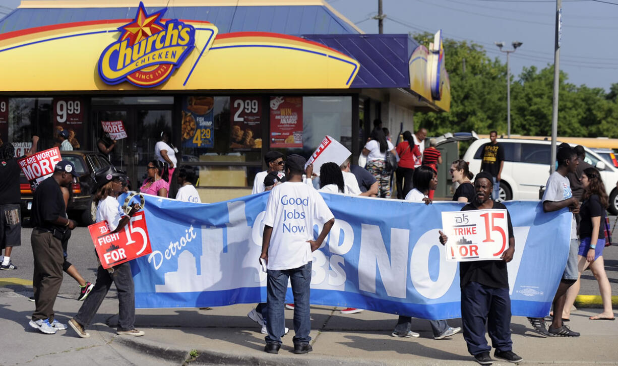 Demonstrators picket in front of the Church's Chicken fast food restaurant in Detroit on Thursday.