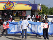 Demonstrators picket in front of the Church's Chicken fast food restaurant in Detroit on Thursday.