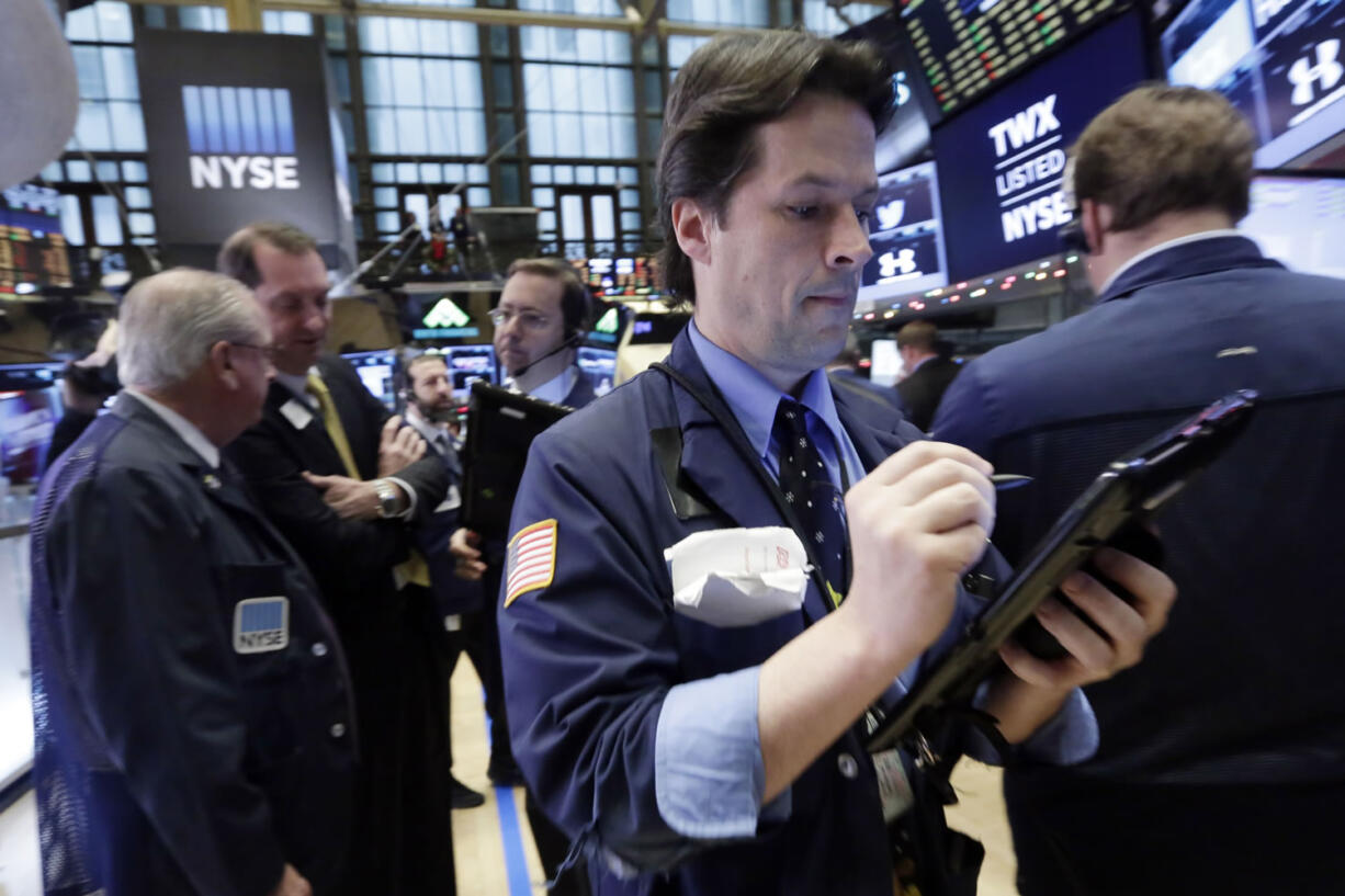 Trader Patrick McKeon, right, works on the floor of the New York Stock Exchange, Monday, Dec. 14, 2015. U.S. stocks are edging lower in early trading as the market comes off its biggest weekly decline since the summer.