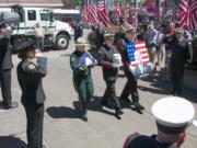 The remains of John Percin Jr. are carried into the Lake Oswego Fire Department Lake Oswego, Ore., where they will lie in state until Friday morning. A public memorial service is scheduled 1 p.m.