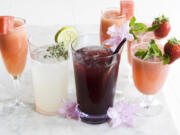 From left: A Watermelon Bellini, White Chiller, Dark Island Cooler, Rose Tinted Glasses wine coolers with a Watermelon Bellini behind them.