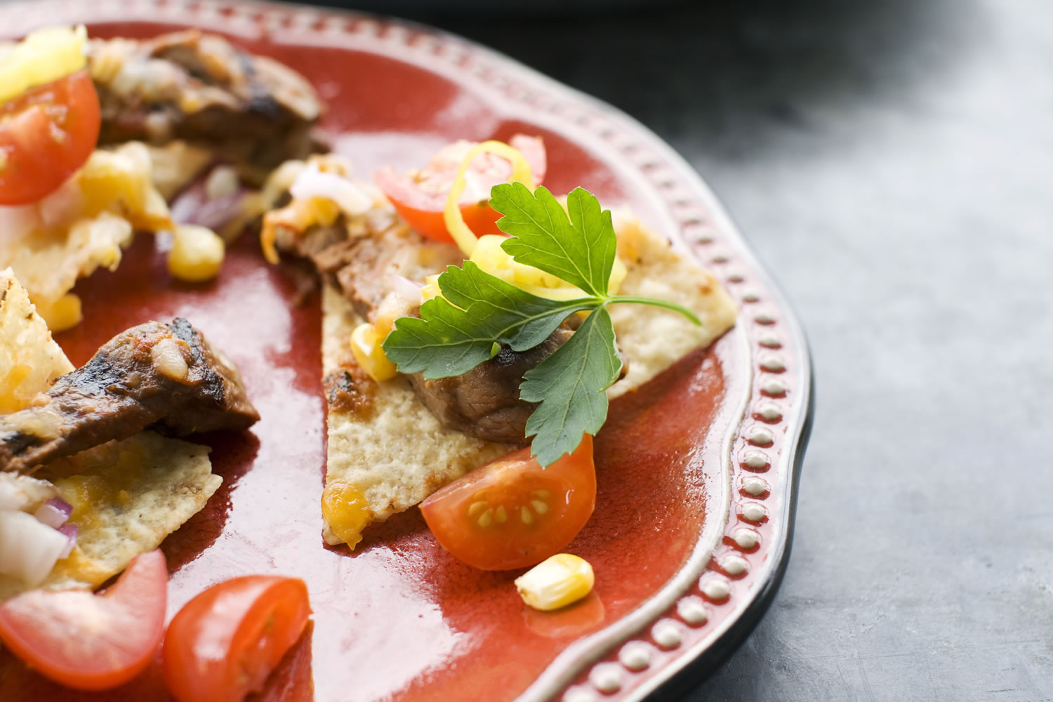 Corn and Steak Grilled Nachos is the next evolution of the layered Mexican dish.