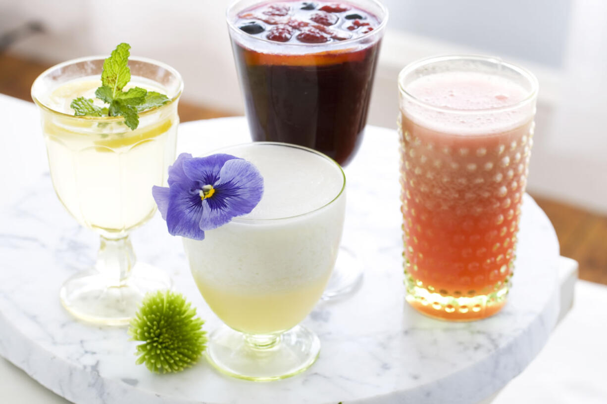 Summer cocktails, clockwise from top: Trashy Red Wine Sangria, Vodka Watermelon Slushie, Pisco Sour and Gin and Bitter Lemon