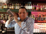 Mixologist Jacques Bezuidenhout prepares a gin Martini cocktail in the Starlight Room of the Sir Francis Drake Hotel in San Francisco.