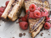 Chocolate-stuffed French toast with raspberry sauce is a nutritious and delicious dish for breakfast in bed.