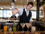 Bartender Nico Reynders makes three different drinks from vodka at the Bistro Boudin in San Francisco.