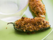 Cheesy sausage-stuffed jalapeno peppers make a great side to a grilled entree or a snack while watching sports.