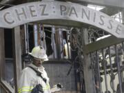 FILE - In this March 8, 2013 file photo, Acting Berkeley Fire Department Deputy Chief Avery Webb inspects damage at Chez Panisse restaurant in Berkeley, Calif. After a fire in March shut the doors to the famous gourmet restaurant, the eatery is preparing to reopen on June 24.