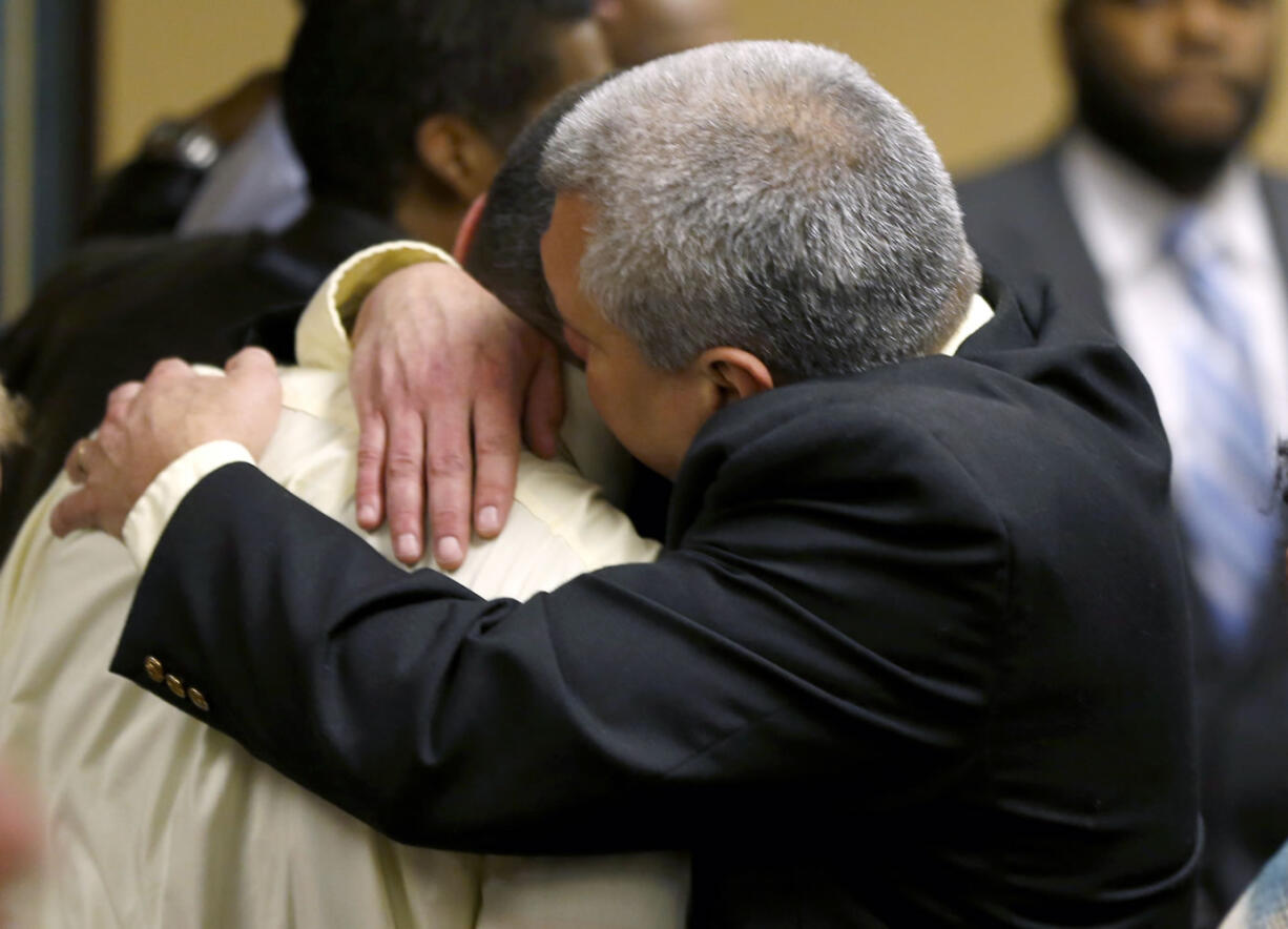 Trent Mays, 17, left, gets a hug from his father, Brian Mays, after Trent and co-defendant Ma'Lik Richmond, 16, were found delinquent on rape and other charges in juvenile court in Steubenville, Ohio, on Sunday.