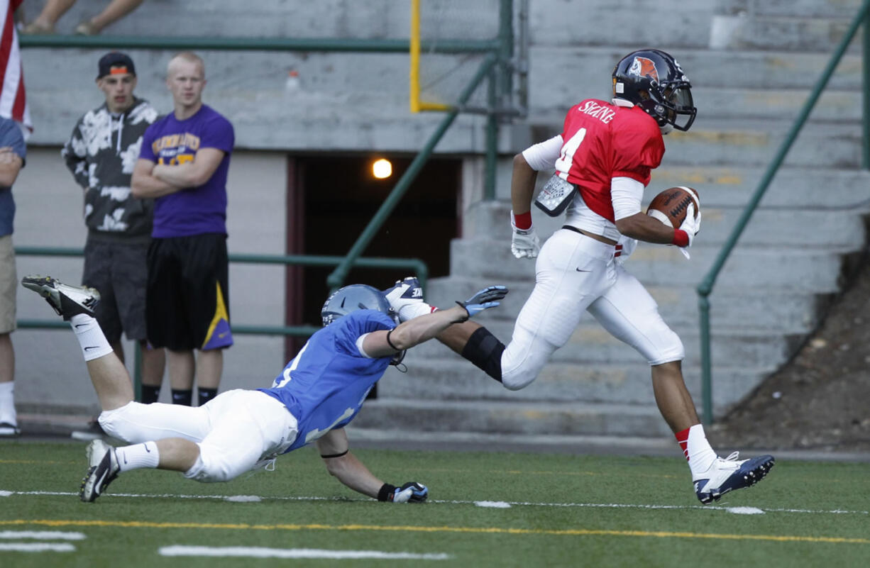 West wide receiver Tony Sparrow sprints to the end zone as East defender Jesse Tonkinson tries to tackle during the Freedom Bowl at Kiggins Bowl.