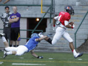 West wide receiver Tony Sparrow sprints to the end zone as East defender Jesse Tonkinson tries to tackle during the Freedom Bowl at Kiggins Bowl.