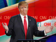 Donald Trump reacts Tuesday during the CNN Republican presidential debate at the Venetian Hotel &amp; Casino in Las Vegas.