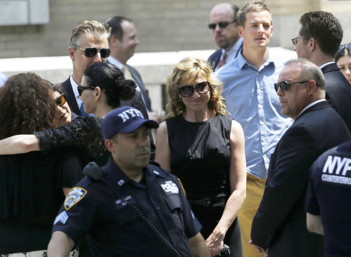 Actress Edie Falco, center, stands outside of Cathedral Church of Saint John the Divine after funeral services for actor James Gandolfini on Thursday in New York.