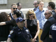 Actress Edie Falco, center, stands outside of Cathedral Church of Saint John the Divine after funeral services for actor James Gandolfini on Thursday in New York.