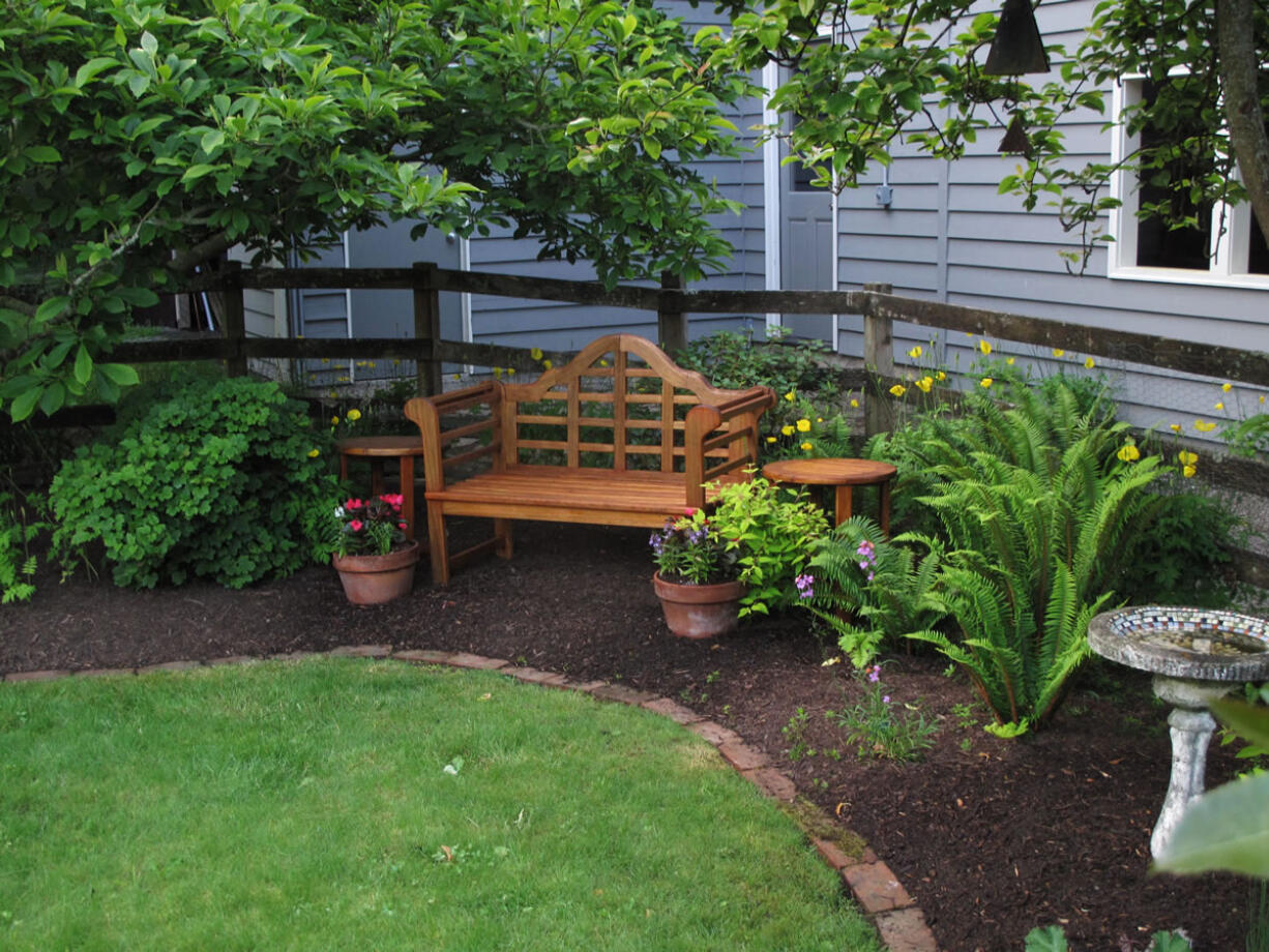 The lawn remains the centerpiece in this yard but was greatly downsized and shaped by a landscaped perimeter with furniture, statuary and a variety of perennials. Less mowing, less watering and fewer chemicals was the result.