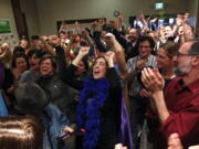 Supporters of Referendum 74, which would uphold the state's new same-sex marriage law, cheer at a news conference Wednesday in Seattle.