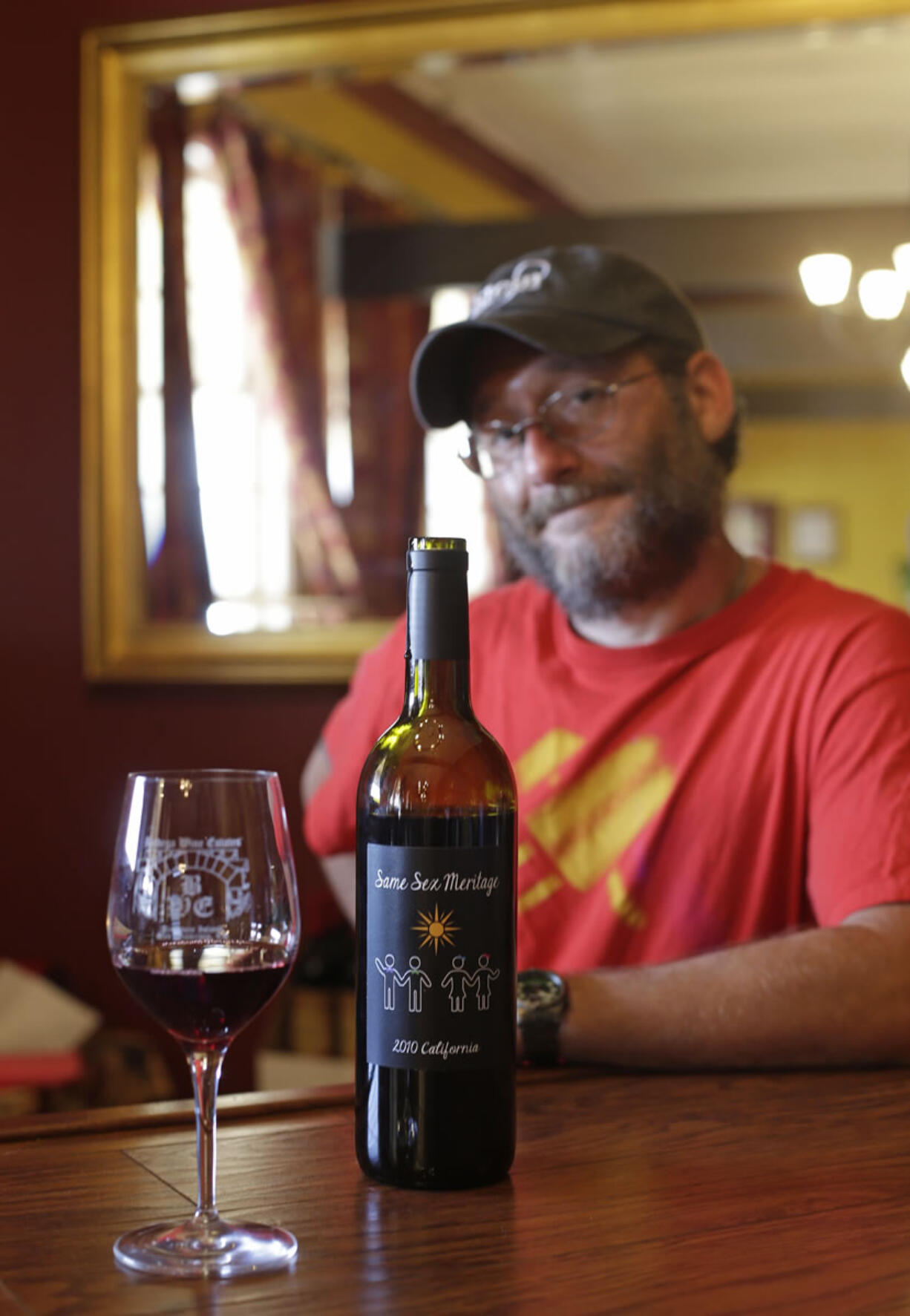 In this photo taken Friday, June 7, 2013, winemaker Josh Stein of Stein Family Wines poses with his Same Sex Meritage red wine at his tasting room on Treasure Island in San Francisco.  Gay marriage has been a hot topic for some months now, so perhaps it's not surprising the wine world has taken note with two new wines that declare their support for same-sex couples right on the label.