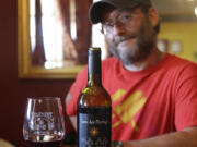 In this photo taken Friday, June 7, 2013, winemaker Josh Stein of Stein Family Wines poses with his Same Sex Meritage red wine at his tasting room on Treasure Island in San Francisco.  Gay marriage has been a hot topic for some months now, so perhaps it's not surprising the wine world has taken note with two new wines that declare their support for same-sex couples right on the label.